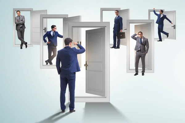 Businessman in uncertainty concept with many doors — Stock Photo, Image