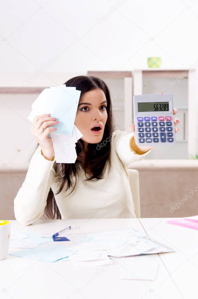 Young woman with receipts in budget planning concept 