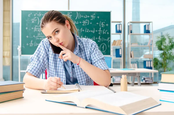 Jonge vrouwelijke student het examen te nemen in de klas — Stockfoto