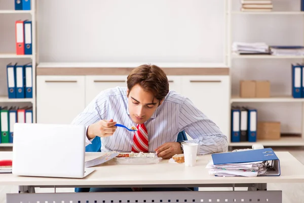 Man having meal at work during break