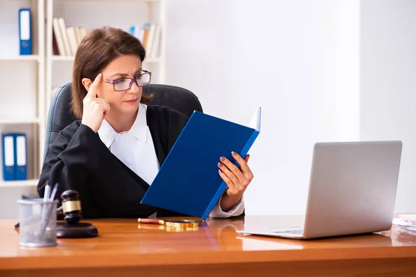 Middle-aged female doctor working in courthouse