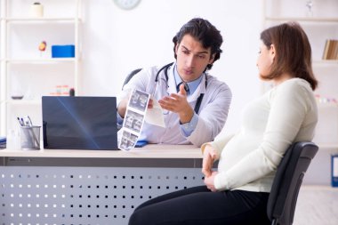 Yaşlı hamile kadın ziyaret genç erkek doktor 