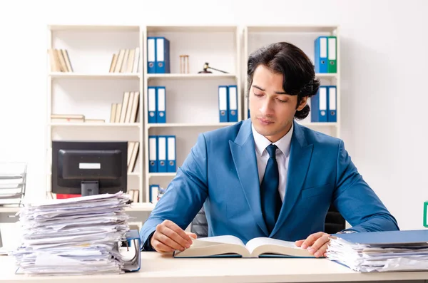 Young handsome busy employee sitting in office — Stock Photo, Image