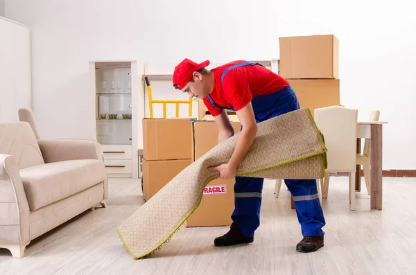 Young contractor with boxes working indoors — Stock Photo, Image