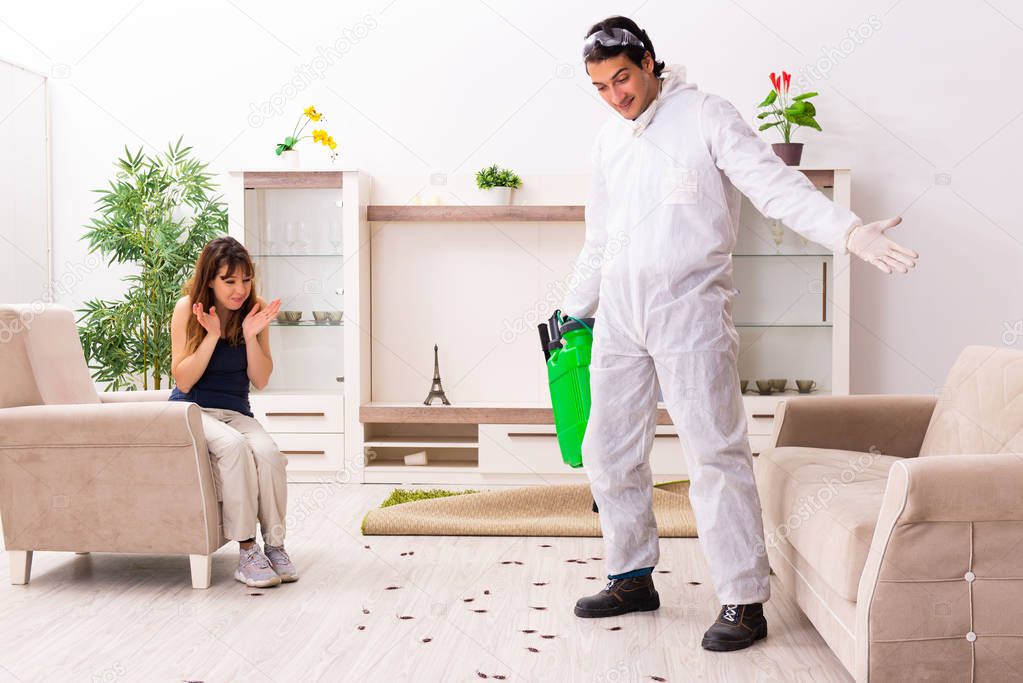 Young professional contractor doing pest control at flat
