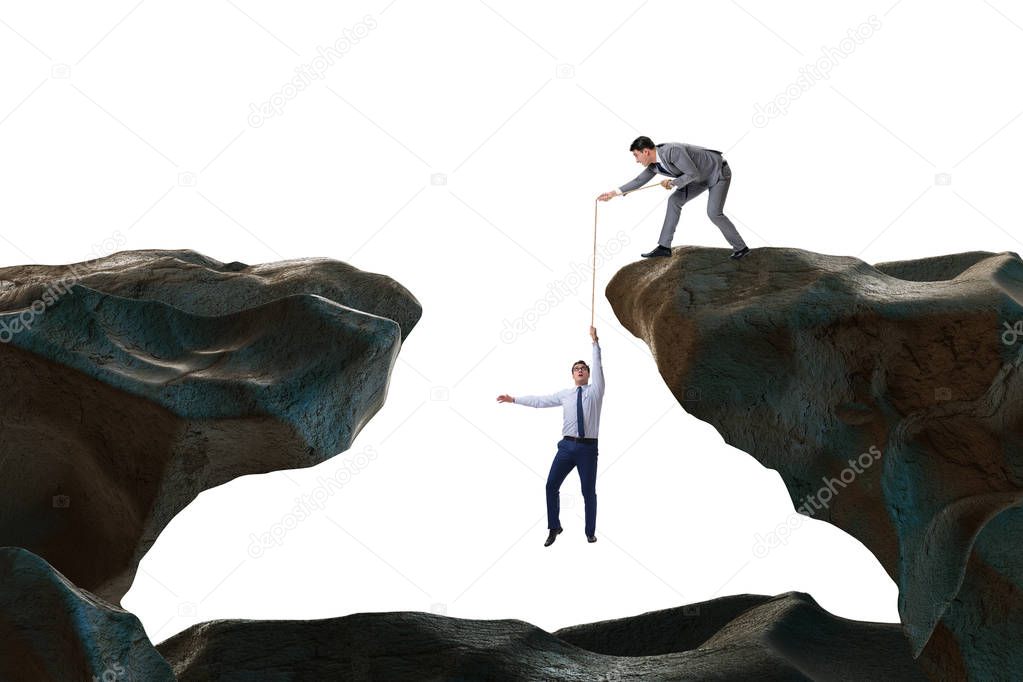 Businessman helping colleague with rope