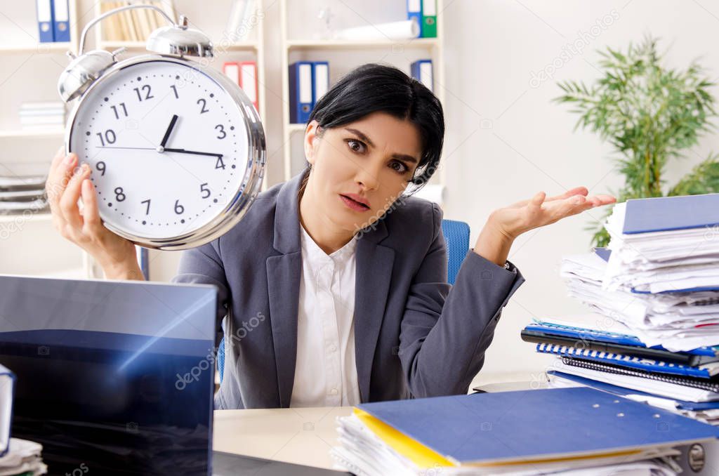 Middle aged businesslady unhappy with excessive work