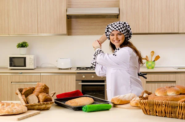 Young female baker working in kitchen — Stock Photo, Image