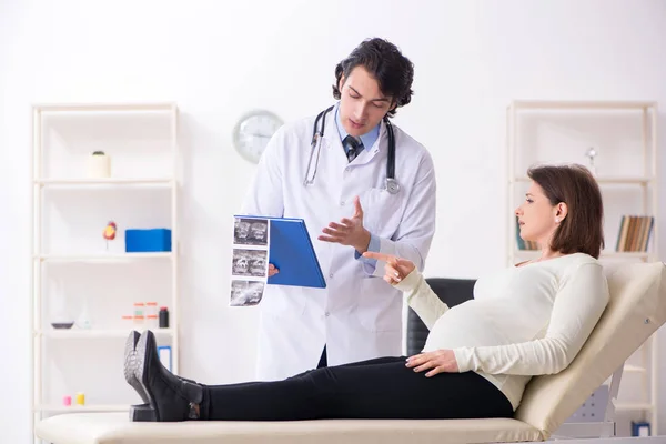 Vecchia donna incinta in visita giovane medico maschio — Foto Stock