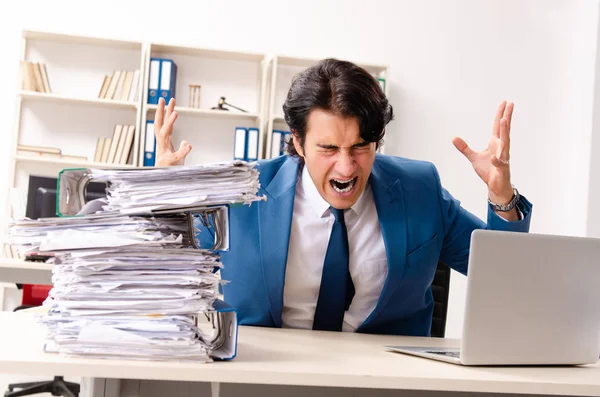 Young handsome busy employee sitting in office — Stock Photo, Image