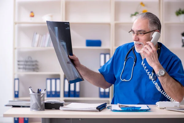 Beyaz sakallı yaşlı doktor radyolog klinikte çalışan — Stok fotoğraf