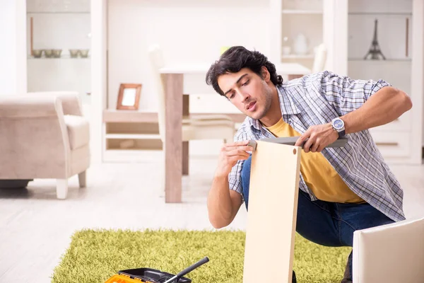 Young handsome man repairing chair at home — Stock Photo, Image