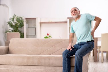 Beyaz sakallı yaşlı adam evde acı