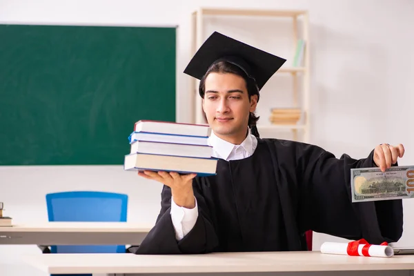 Estudante graduado na frente do quadro verde — Fotografia de Stock