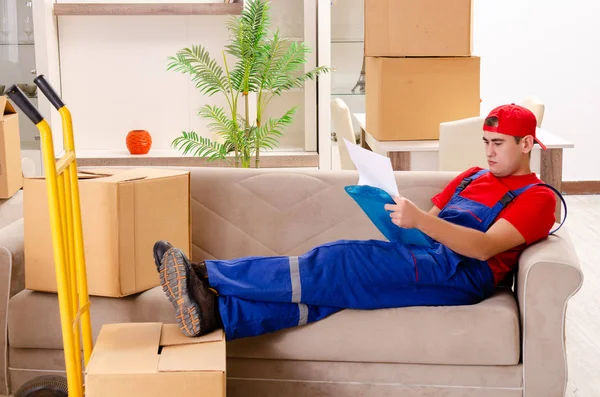 Young contractor with boxes working indoors — Stock Photo, Image