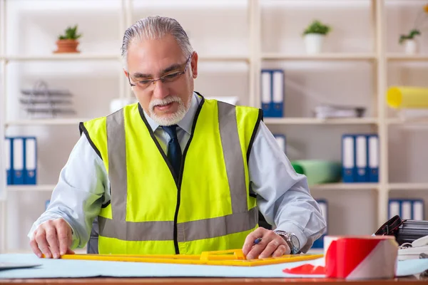 År byggnadsingenjör arbetar på kontoret — Stockfoto