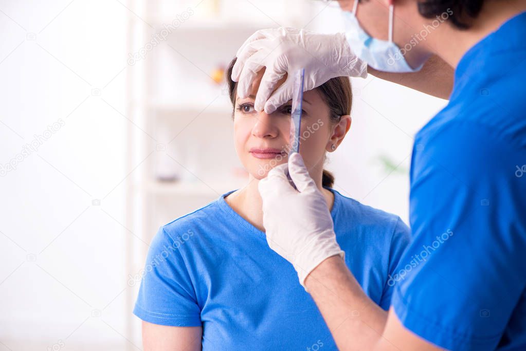 Woman visiting male doctor for plastic surgery
