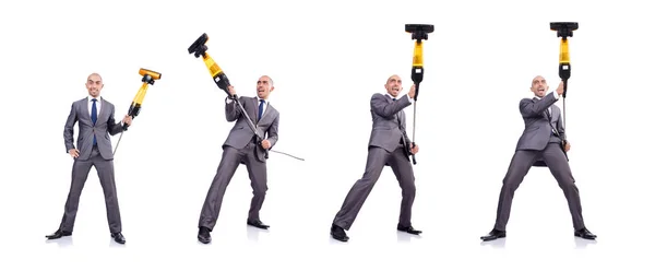 Businessman doing vacuum cleaning on white — Stock Photo, Image