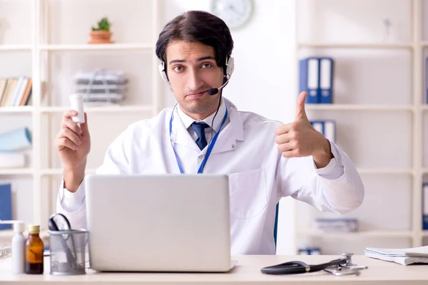 Young male doctor in telemedicine concept — Stock Photo, Image