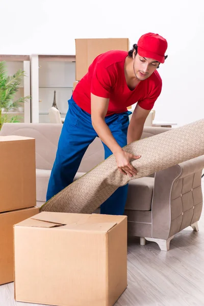 Young male contractor with boxes working indoors — Stock Photo, Image