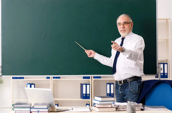 칠판 앞에서 있는 나이든 남자 교사 — 스톡 사진