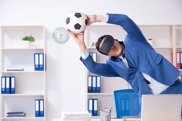 Young handsome businessman playing soccer with virtual glasses — Stock Photo, Image
