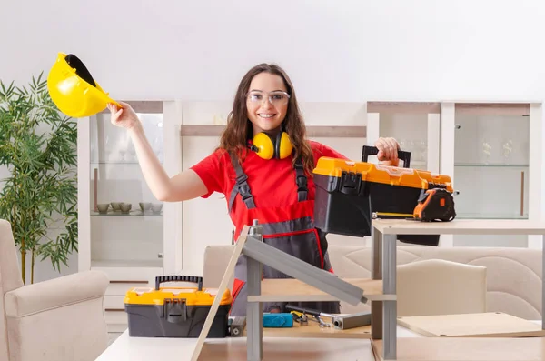 Female contractor repairing furniture at home