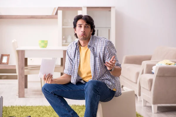 Young handsome man repairing chair at home — Stock Photo, Image