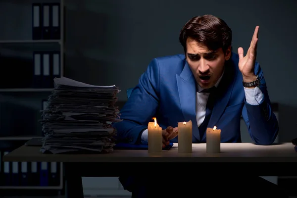 Businessman working late in office with candle light — Stock Photo, Image