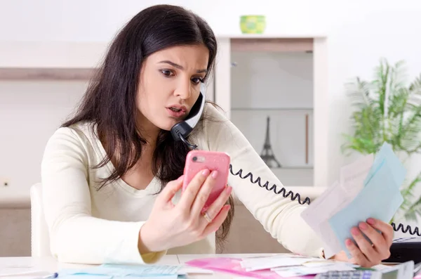 Young woman with receipts in budget planning concept — Stock Photo, Image