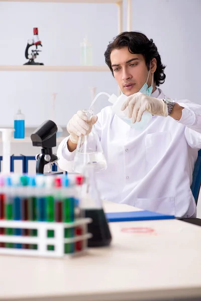 Jonge knappe chemicus die in het lab werkt — Stockfoto