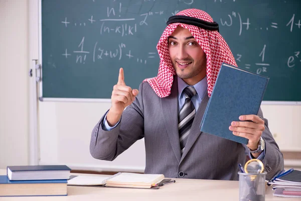 Emiraty nauczyciel nosi garnitur przed chalkboard — Zdjęcie stockowe