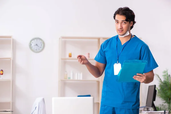 Young handsome doctor working in the clinic — Stock Photo, Image