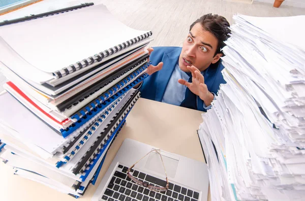 Young handsome businessman unhappy with excessive work — Stock Photo, Image