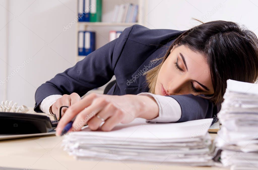 Young female employee sleeping in the office