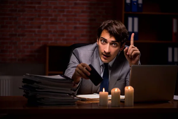 Zakenman werkt laat op kantoor met kaarslicht — Stockfoto
