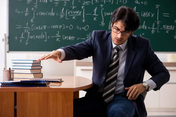 Jonge mannelijke wiskundeleraar in de klas — Stockfoto