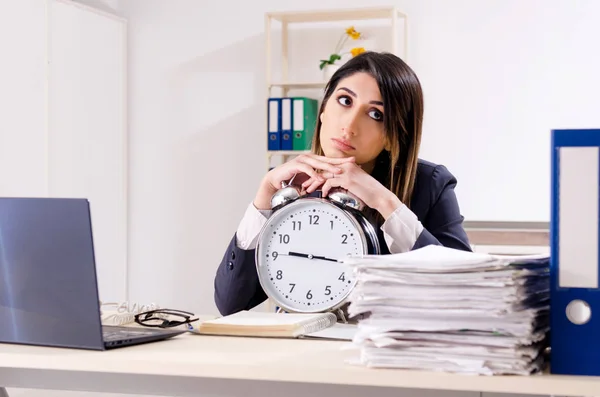 Joven empleada en concepto de gestión del tiempo — Foto de Stock