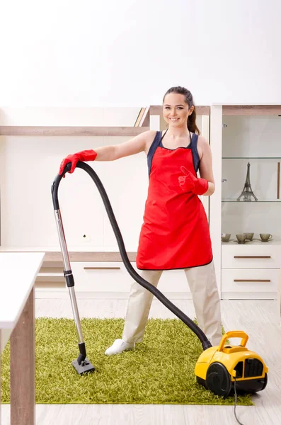 Young beautiful woman cleaning apartment