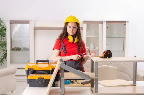 Female contractor repairing furniture at home