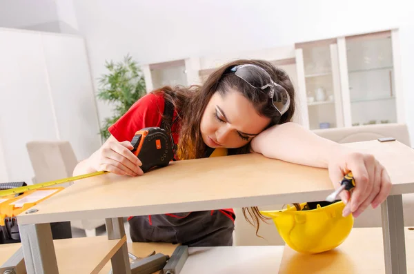 Female contractor repairing furniture at home