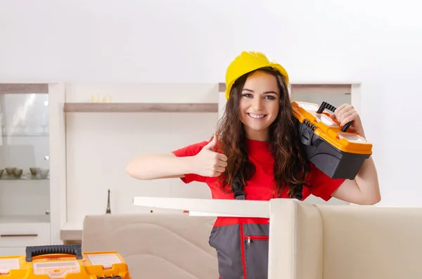 Female contractor repairing furniture at home