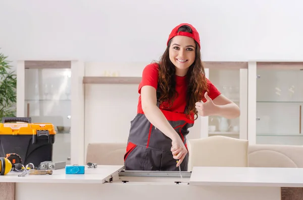 Female contractor repairing furniture at home