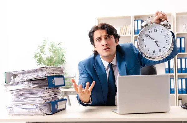 Young handsome busy employee sitting in office — Stock Photo, Image