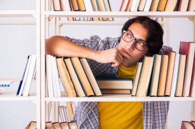 Erkek öğrenci kütüphanede sınava hazırlanıyor 