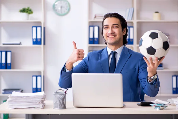 Young handsome businessman with soccer ball in the office — Stock Photo, Image
