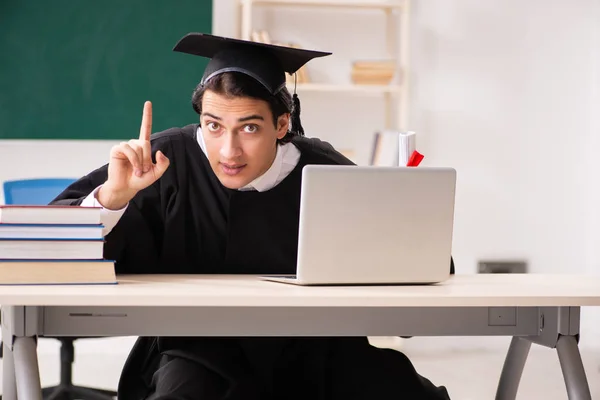 Graduate student in front of green board — Stock Photo, Image