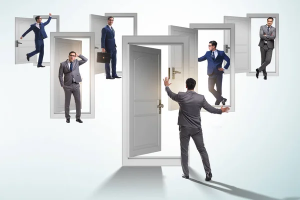 Businessman in uncertainty concept with many doors — Stock Photo, Image