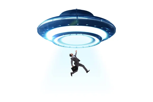 Flying saucer abducting young businessman — Stock Photo, Image