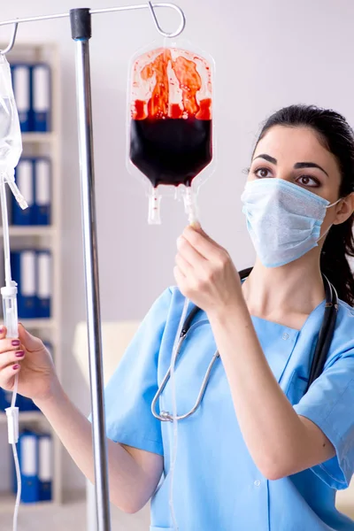 Young female doctor in infusion concept — Stock Photo, Image